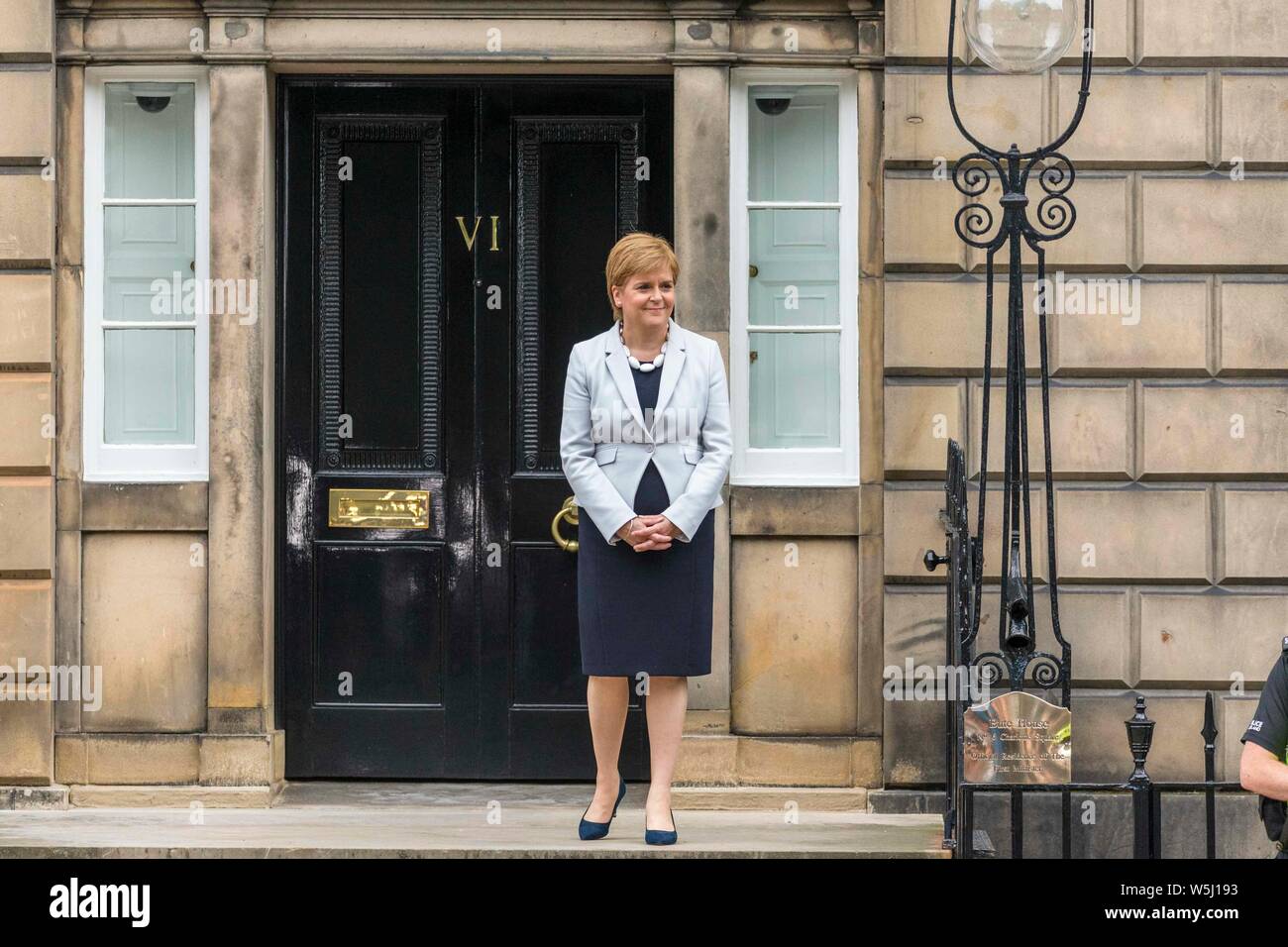 Edinburgh, UK. 29th July, 2019. Prime Minister and Conservative Leader, Boris Johnson visits Bute House to meet First Minister of Scotland, Nicola Sturgeon. Earlier in the day, Johnson announced £300m of funding for projects to boost the economy in Scotland, Wales and Northern Ireland. Pictured: FM Nicola Sturgeon smiles as the awaiting crowds shouts at the Prime Minister Credit: Rich Dyson/Alamy Live News Stock Photo