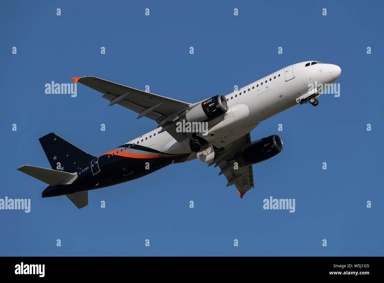 A Titan Airways Airbus A320-200 takes off from Manchester International Airport (Editorial use only) Stock Photo