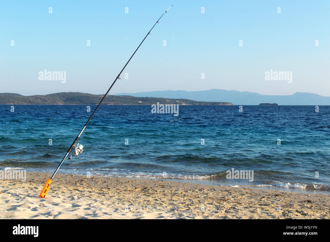 Fishing rod on beach shore Stock Photo Alamy