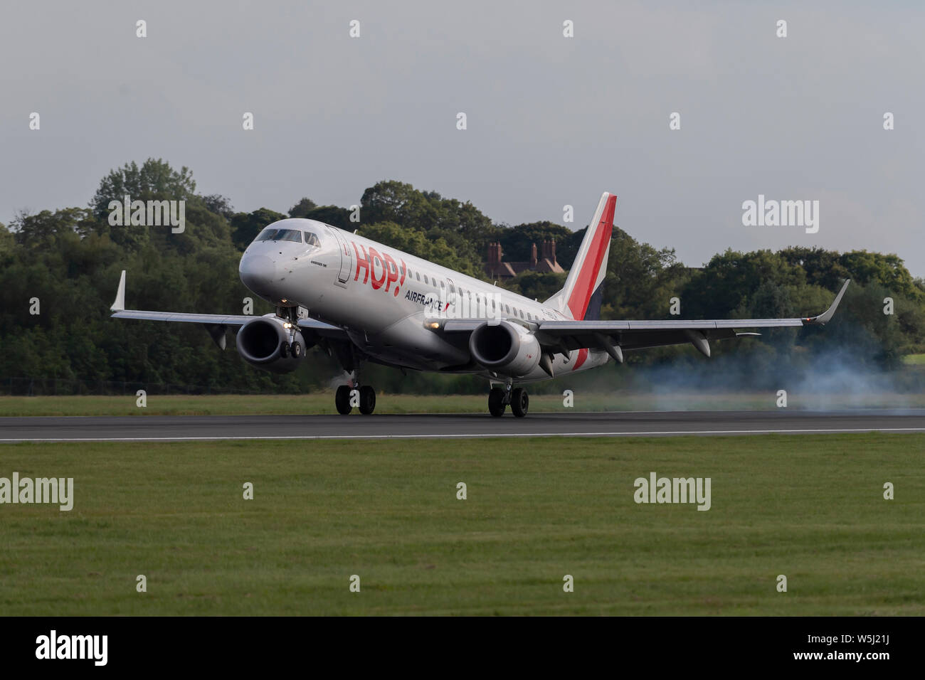 A HOP! Embraer ERJ-190 lands at Manchester International Airport (Editorial use only) Stock Photo