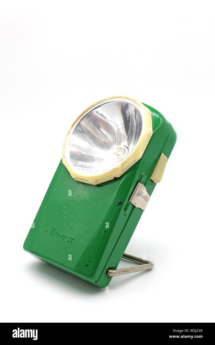 Vintage green metal flashlight torch, isolated on a white background Stock Photo