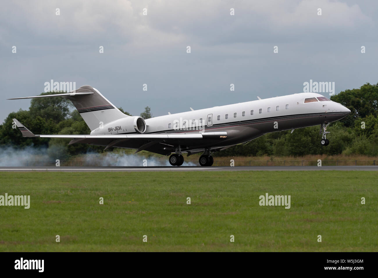 A Bombardier Global 6000 private jet lands at Manchester International Airport (Editorial use only) Stock Photo