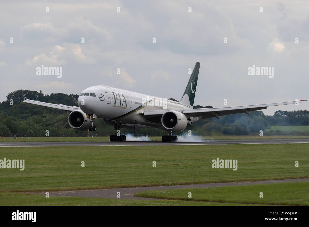 A Pakistan International Airlines airliner lands at Manchester International Airport (Editorial use only) Stock Photo