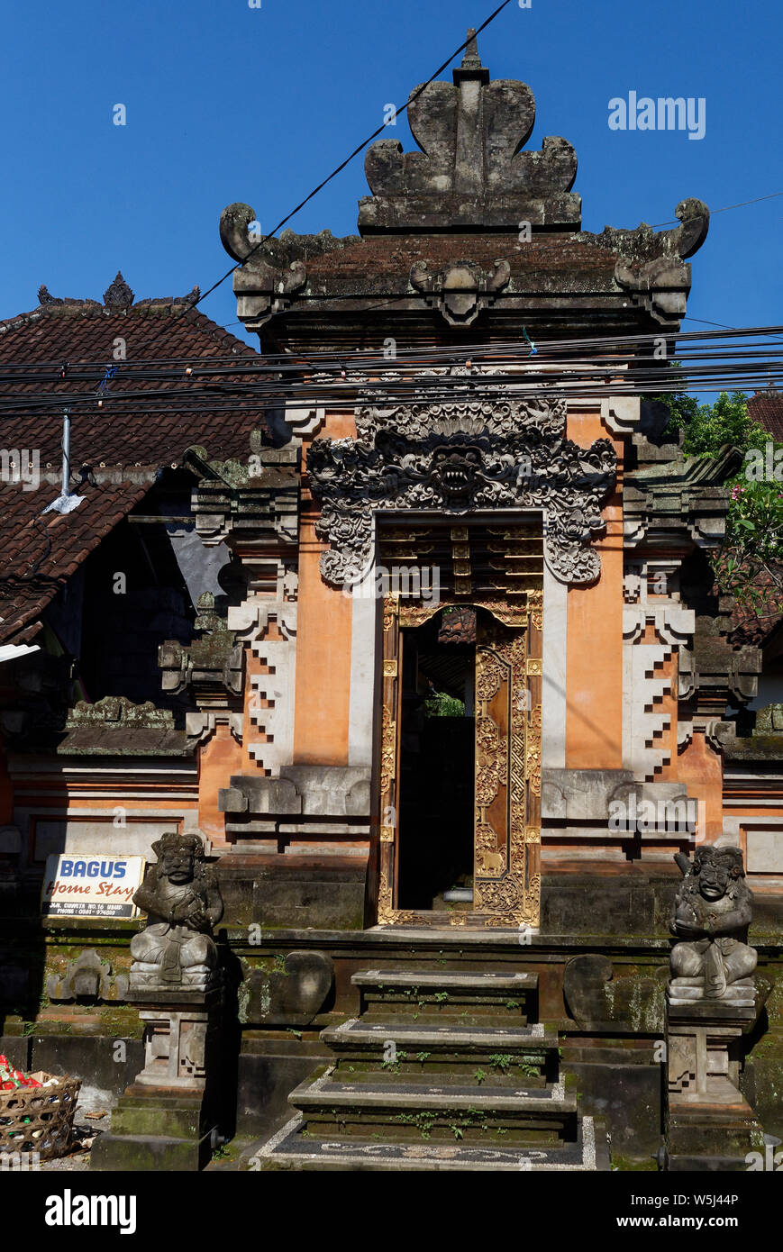 Doors and entrances to homes and palaces are decorated with symbols and faces to protect them from the outside.in Ubud, Bali, Indonesia Stock Photo