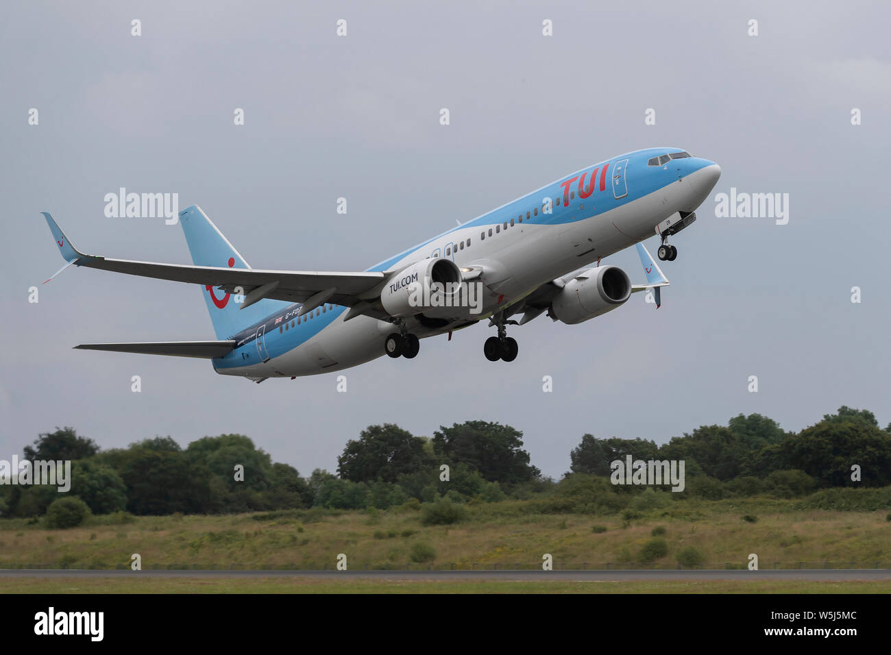 A TUI Airways Boeing 737-800 takes off from Manchester International Airport (Editorial use only) Stock Photo