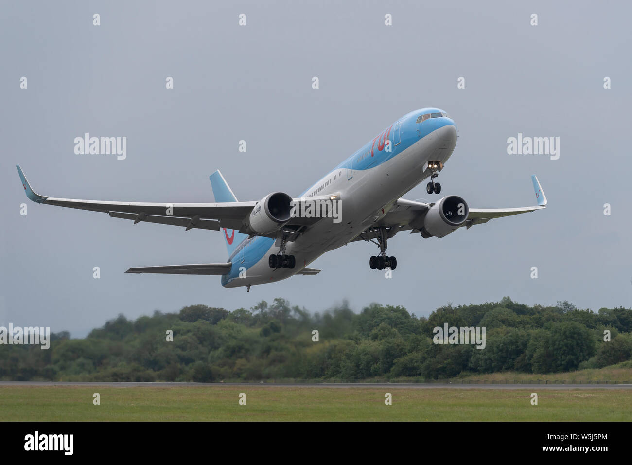 A TUI Airways Boeing 767-300 takes off from Manchester International Airport (Editorial use only) Stock Photo