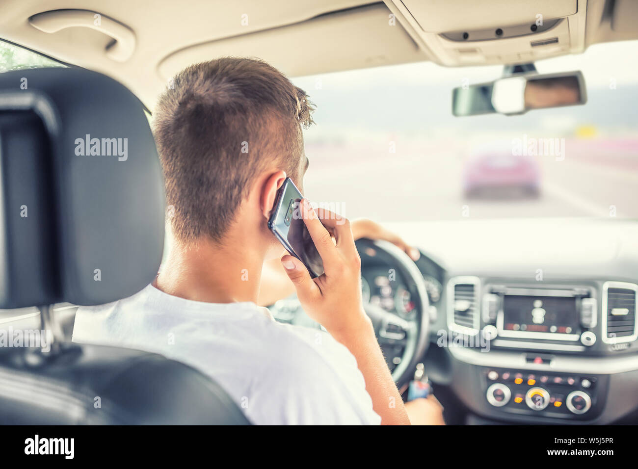 Man driving car and calling  from smartphone. Stock Photo