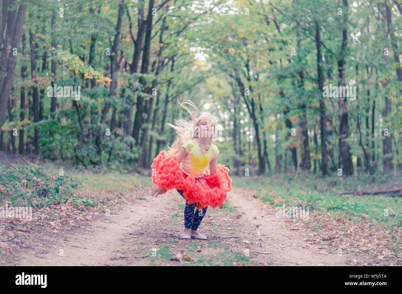 teenage girl in rural path among autumnal trees in forest Stock Photo ...
