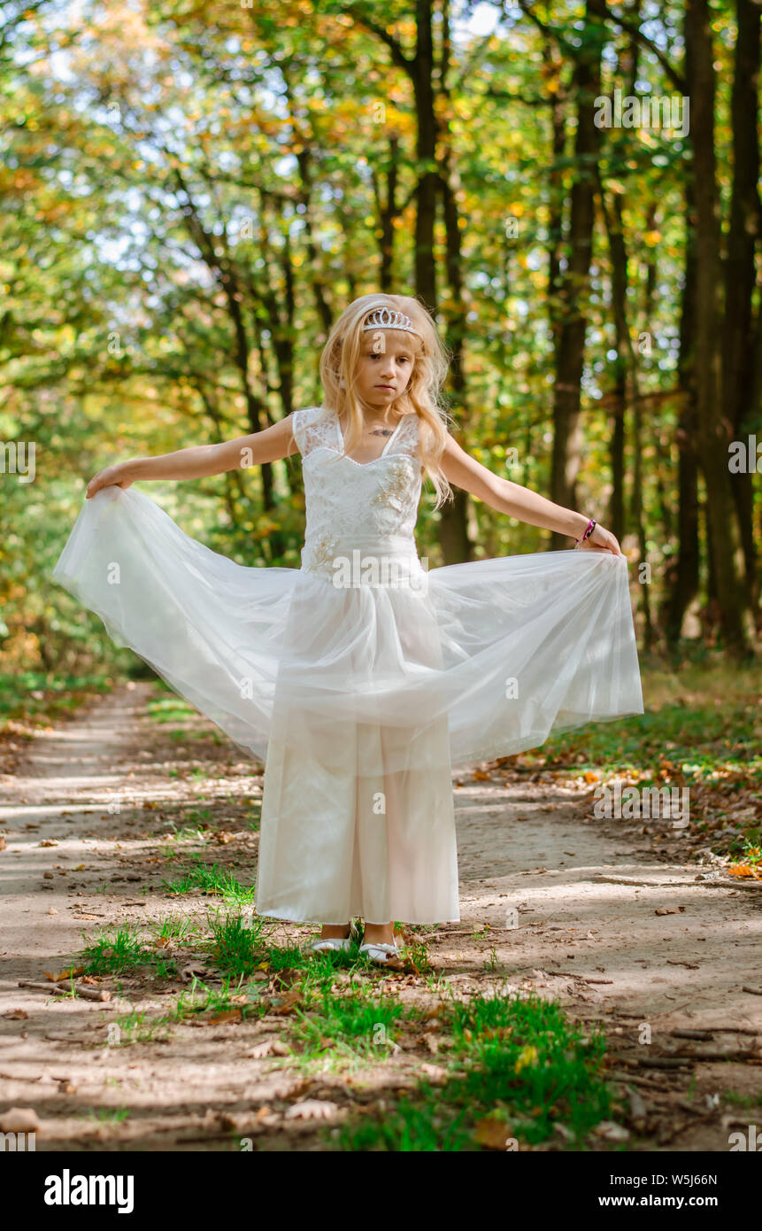 cute little girl in long white wedding dress Stock Photo