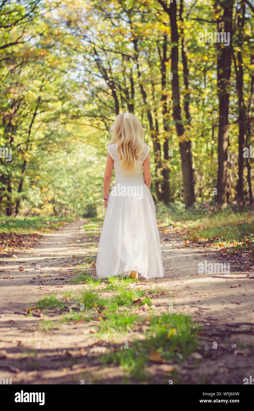 cute little girl in long white wedding dress Stock Photo