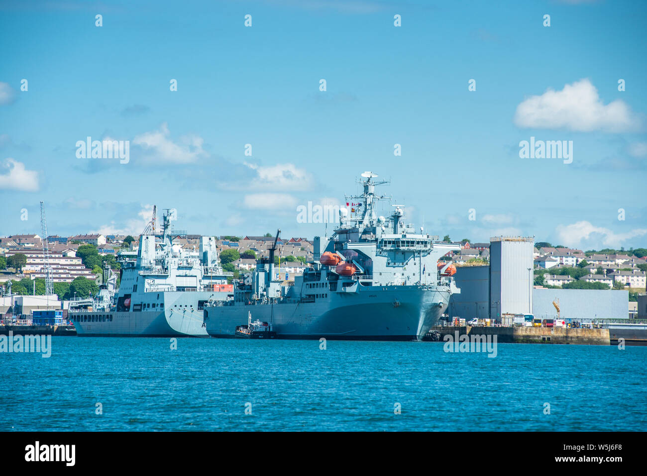 RFA Argus & RFA Tidesurge a Tide-class replenishment tanker of British Royal Fleet Auxiliary at Frigate Refit Complex HMNB Devonport, Plymouth, Devon Stock Photo