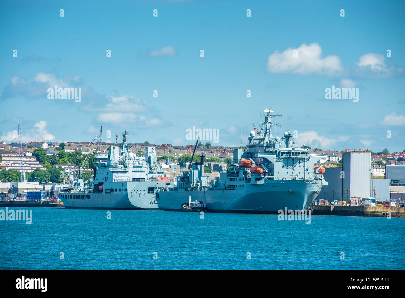 RFA Argus & RFA Tidesurge a Tide-class replenishment tanker of British Royal Fleet Auxiliary at Frigate Refit Complex HMNB Devonport, Plymouth, Devon Stock Photo