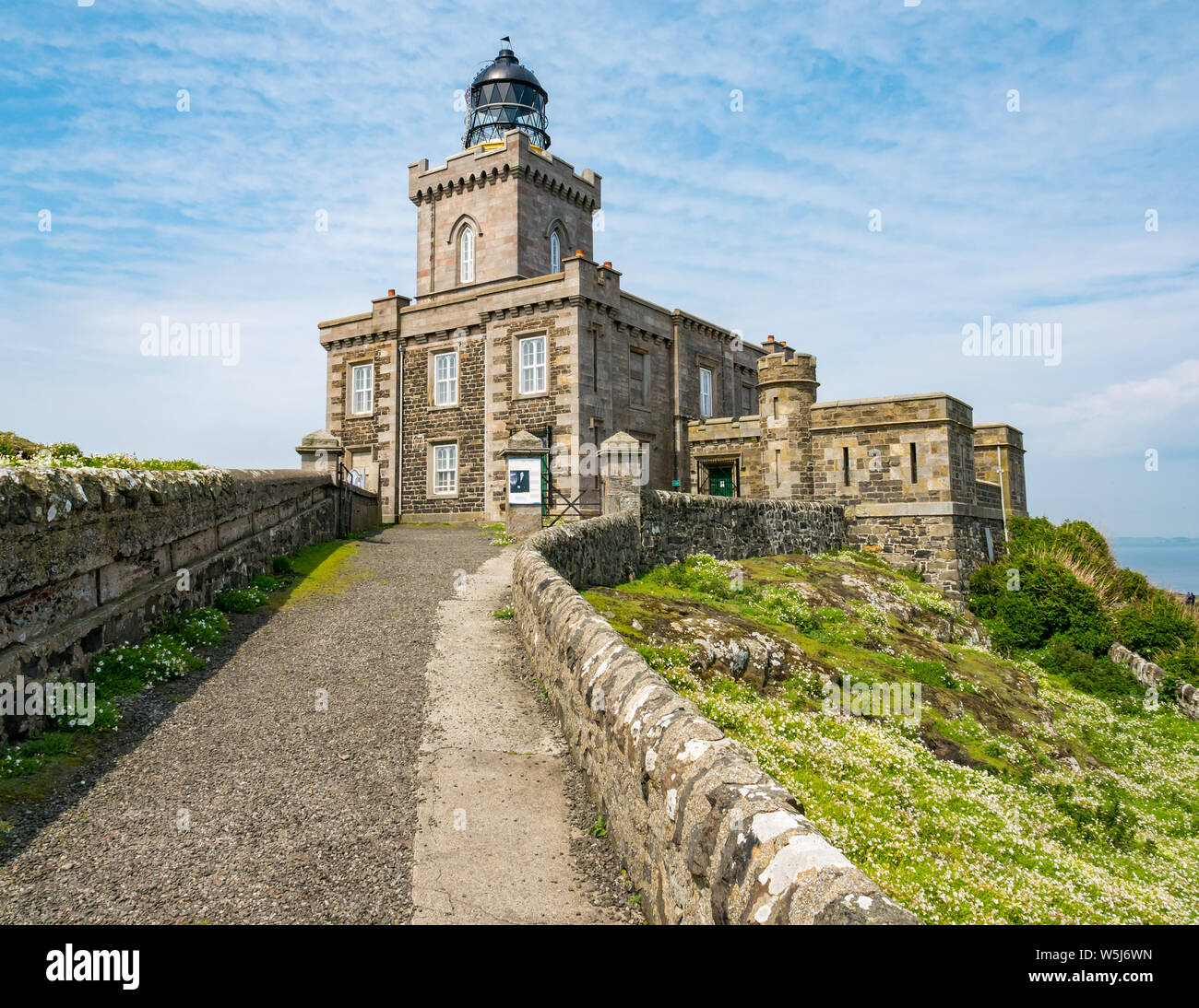 Path leading to grand Victorian lighthouse building with lantern, Isle of May, Scotland, UK Stock Photo