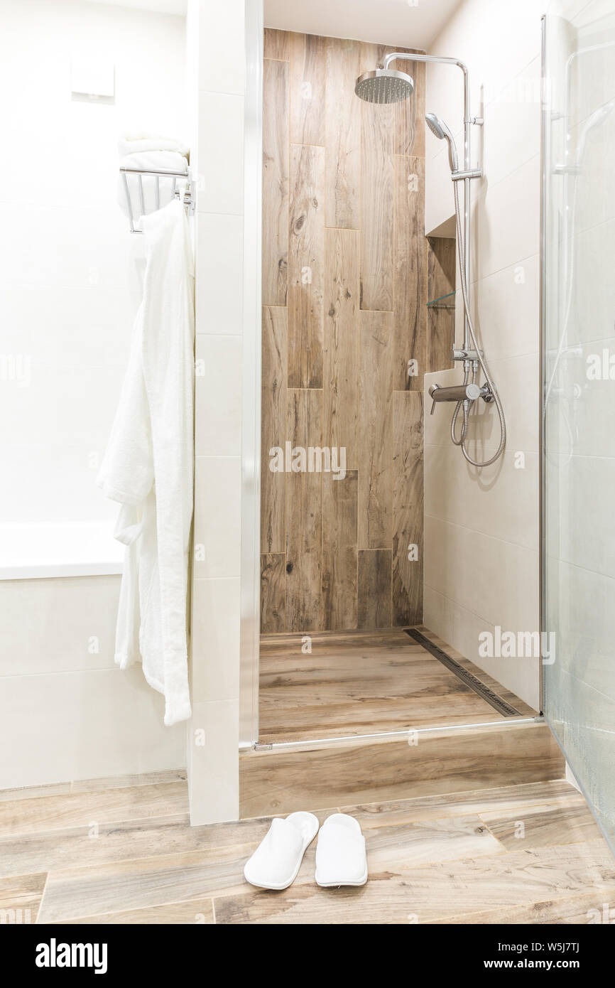 Walk In Shower In Bathroom With Wooden Style Tile Stock Photo