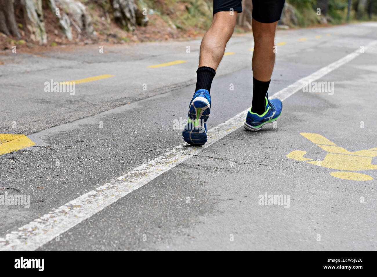 Runner/ Focus on runner legs and shoes/ Conceptual image of health and healthy lifestyle Stock Photo