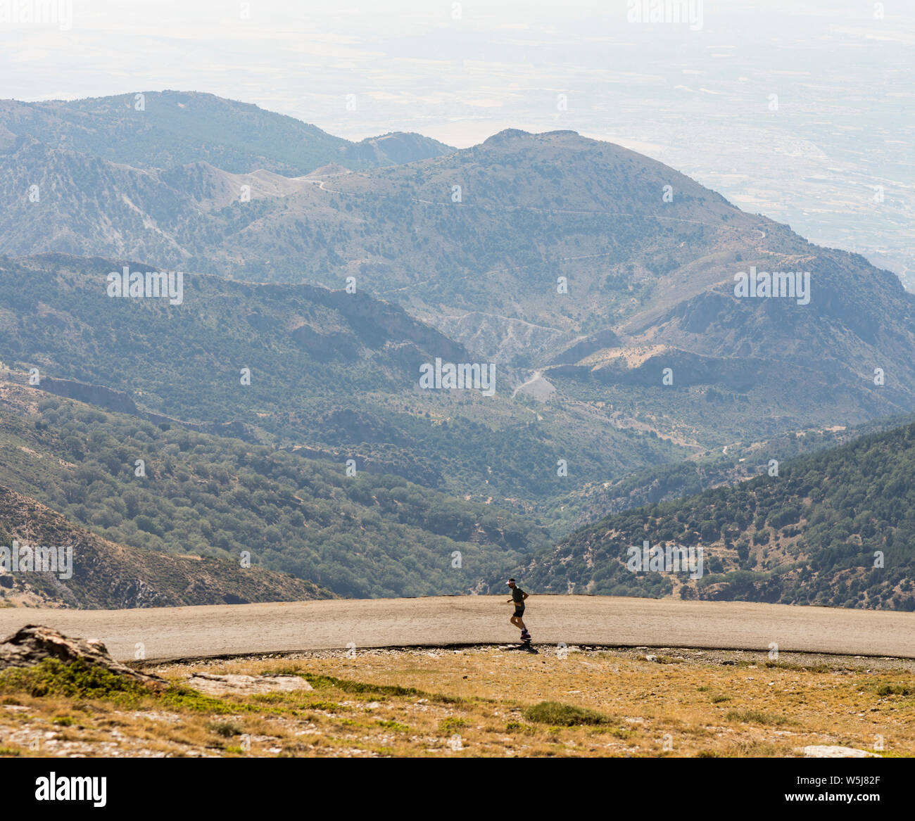 Man running, at 2500m altitude, Sierra Nevada mountains, summer season