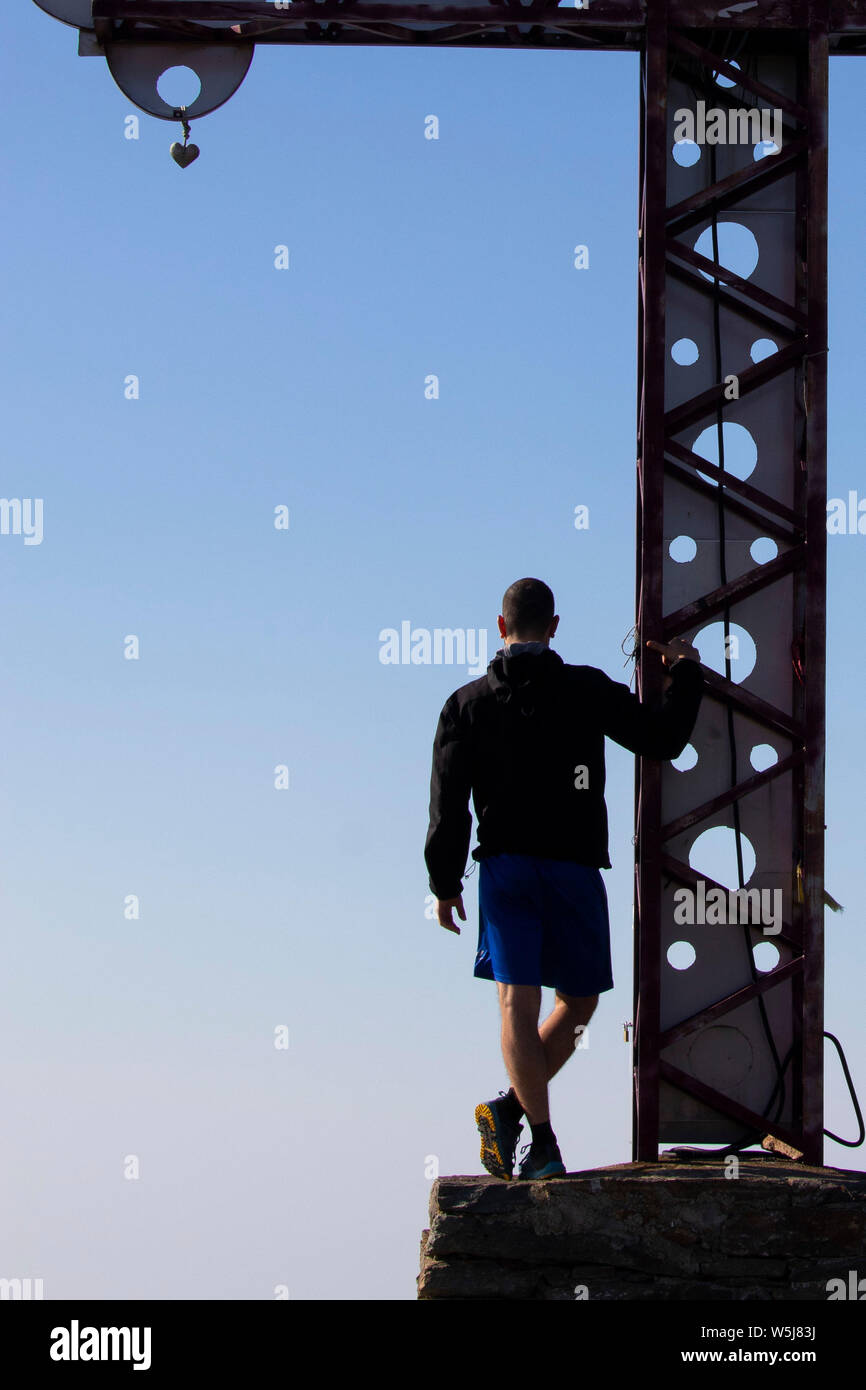 One man, under rood, on top of the mountain Stock Photo - Alamy