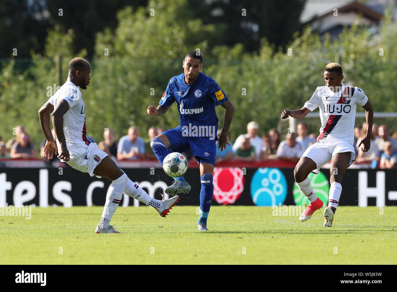 29 July 2019, Austria, Kitzbühel: Soccer: Test matches, FC Schalke 04 - FC Bologna. Bolognas Stefano Denswil (l-r) together with Bolognas Kingsley Michael in a duel with Schalkes Omar Mascarell Photo: Tim Rehbein/dpa Stock Photo