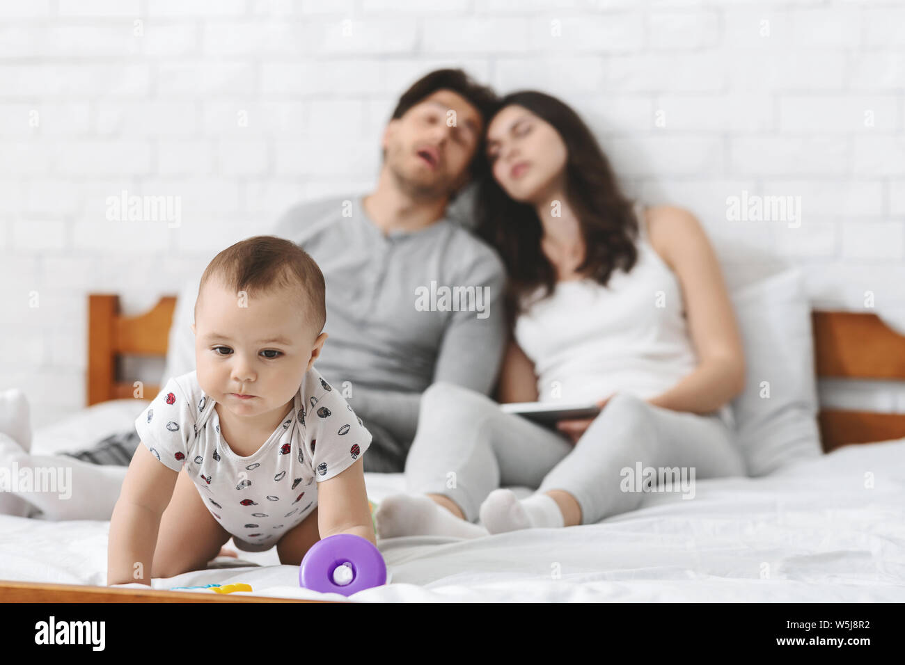 Baby risk of fall out of bed, crawling to side Stock Photo Alamy