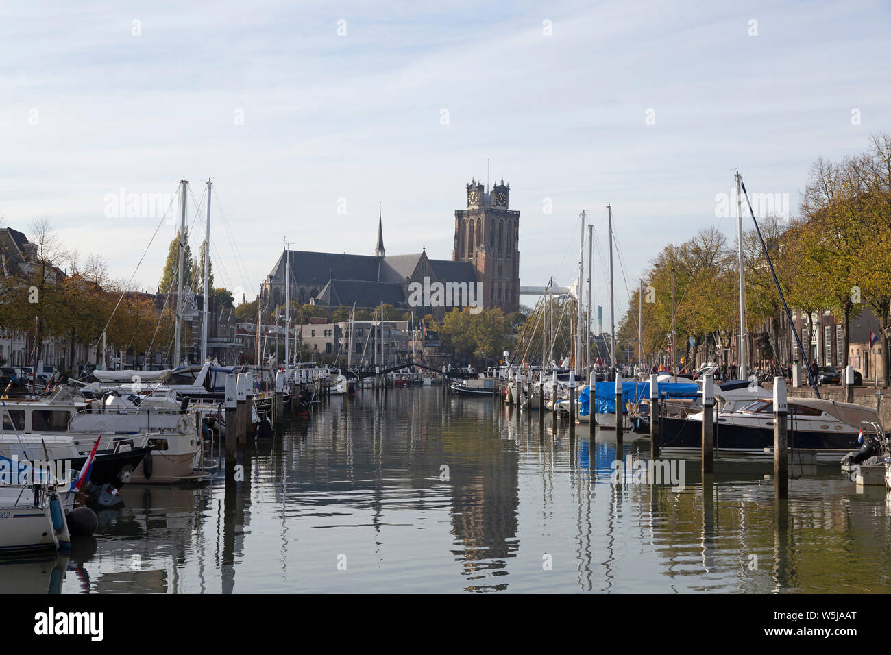 The Grote Kerk (Onze-Lieve-Vrouwe-Kerk) seen from the Nieuwe Haven in Dordrecht, the Netherlands. The church has a leaning tower. Stock Photo