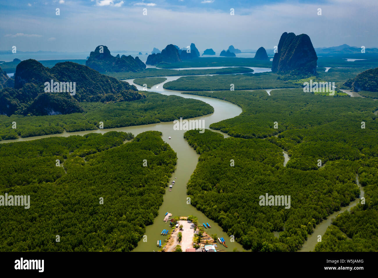 Aerial drone view of a small pier with traditional wooden Longtail