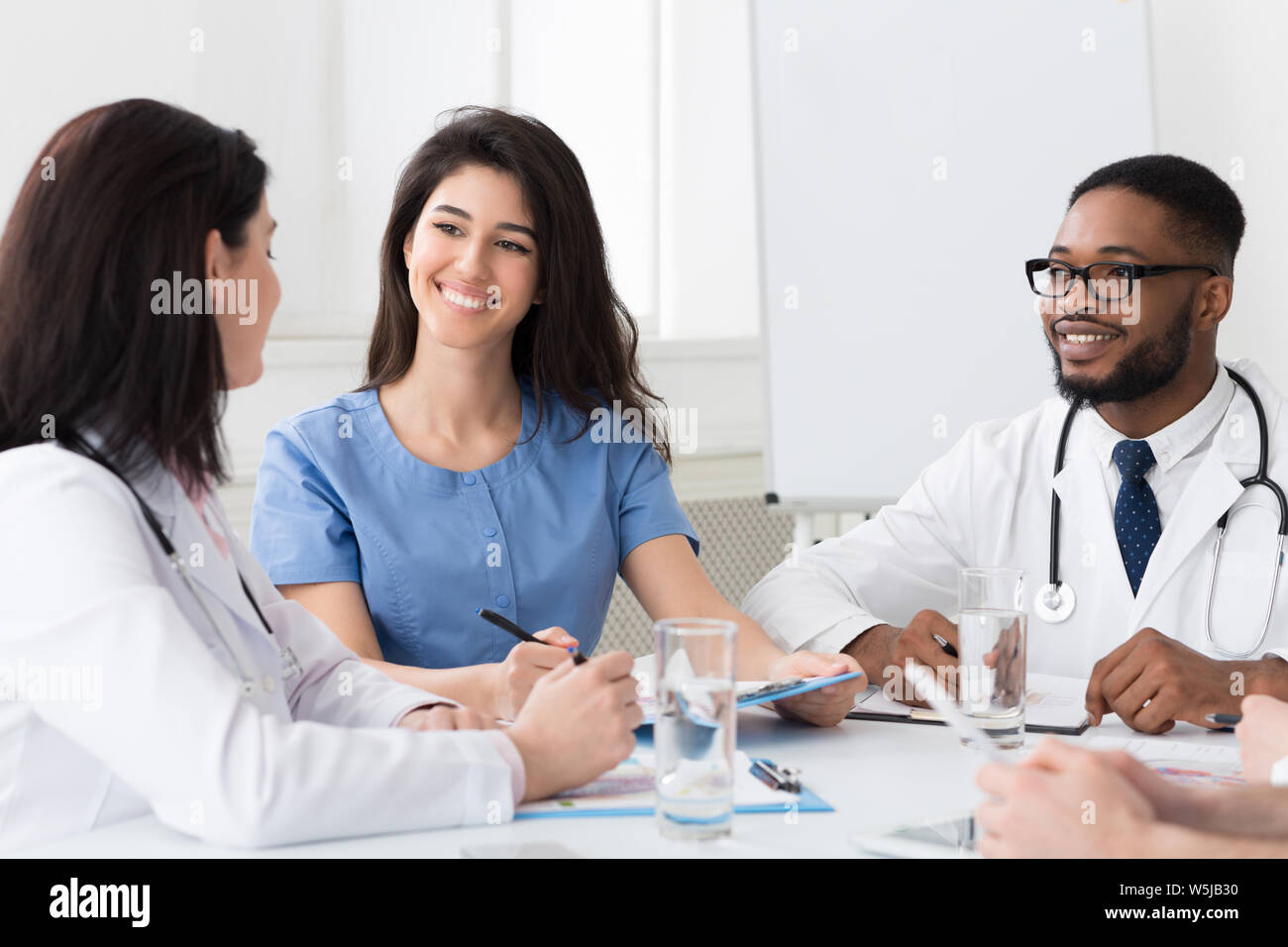Intern with mentor talking and discussing questions Stock Photo