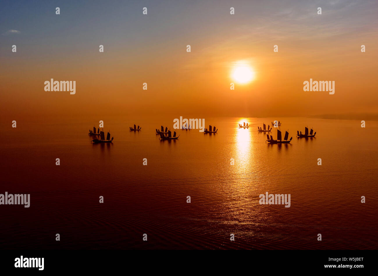 Fishing junks at sunrise on Lake Tai, Huzhou, China Stock Photo