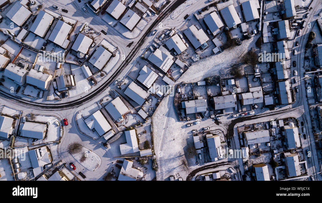 Aerial drone view of winding residential roads surrounded by fresh snowfall Stock Photo