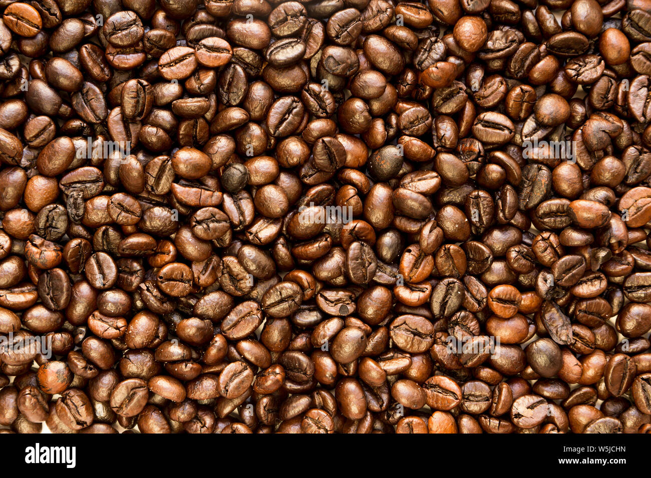 the texture of the coffee beans roasted Brown background Stock Photo ...