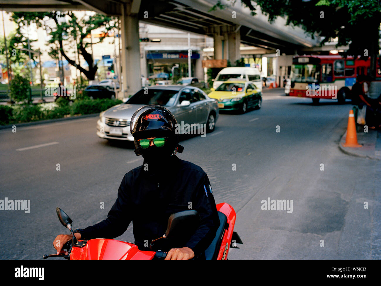 Man in green sunglasses on Sukhumvit in Bangkok in Thailand in Southeast Asia Far East. Surreal Surrealism Stock Photo