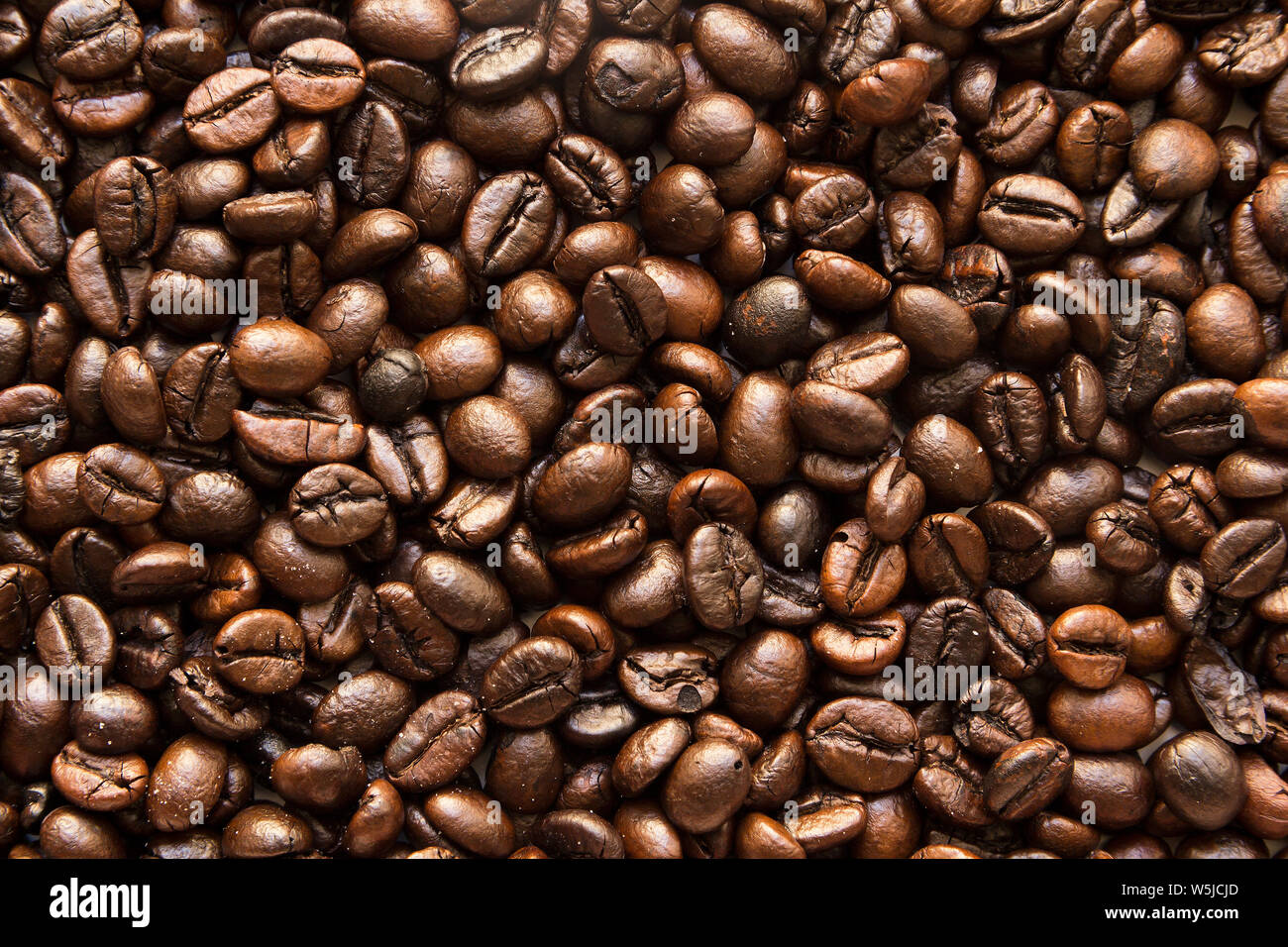 the texture of the coffee beans roasted Brown background Stock Photo ...