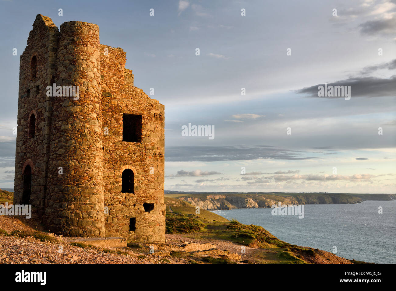 Abandoned Stamps and Whim Engine house at Wheal Coates tine mine on the Celtic Sea Cornwall England with RAF Portreath on clifftops Stock Photo