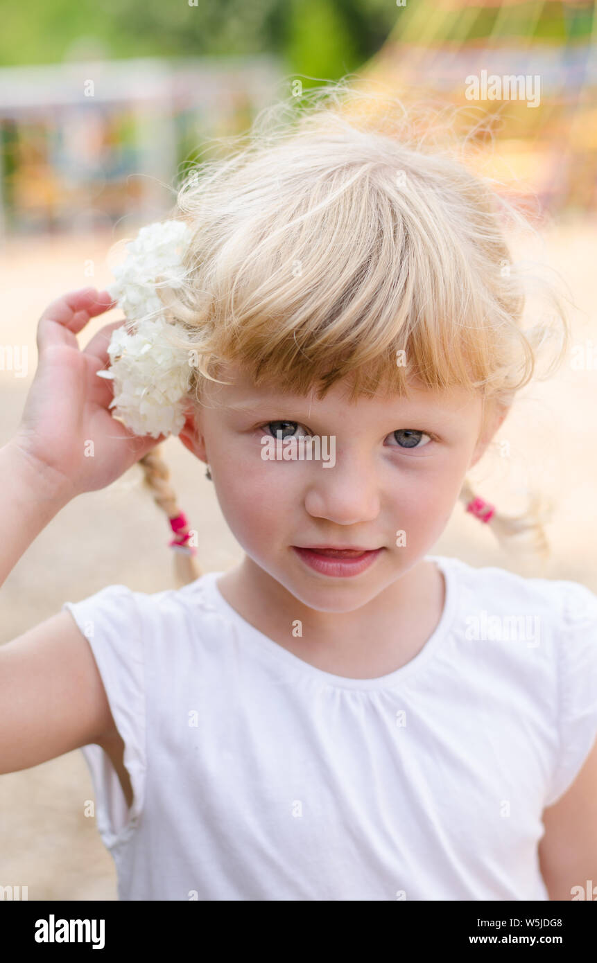 beautiful blond girl with flower in hair Stock Photo - Alamy