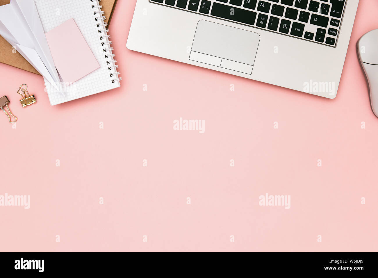 Flat lay image of pink office desk table with laptop, office supplies and copy space. Hero header concept. Top view. Stock Photo