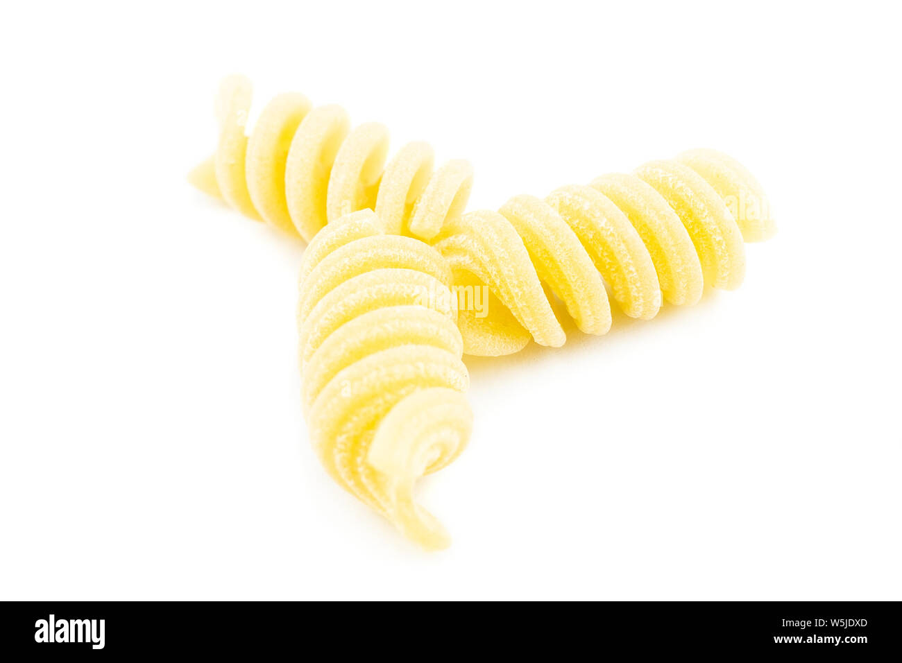 uncooked fusilli pasta noodles isolated on white background Stock Photo