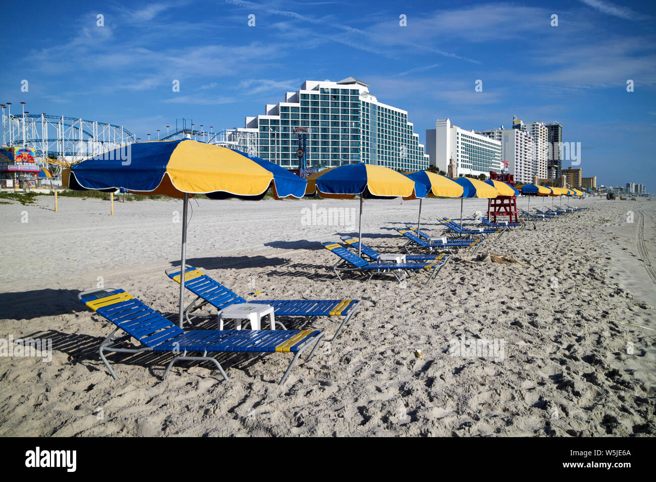 empty sun loungers and umbrellas for hire early morning daytona beach florida usa united states of america Stock Photo