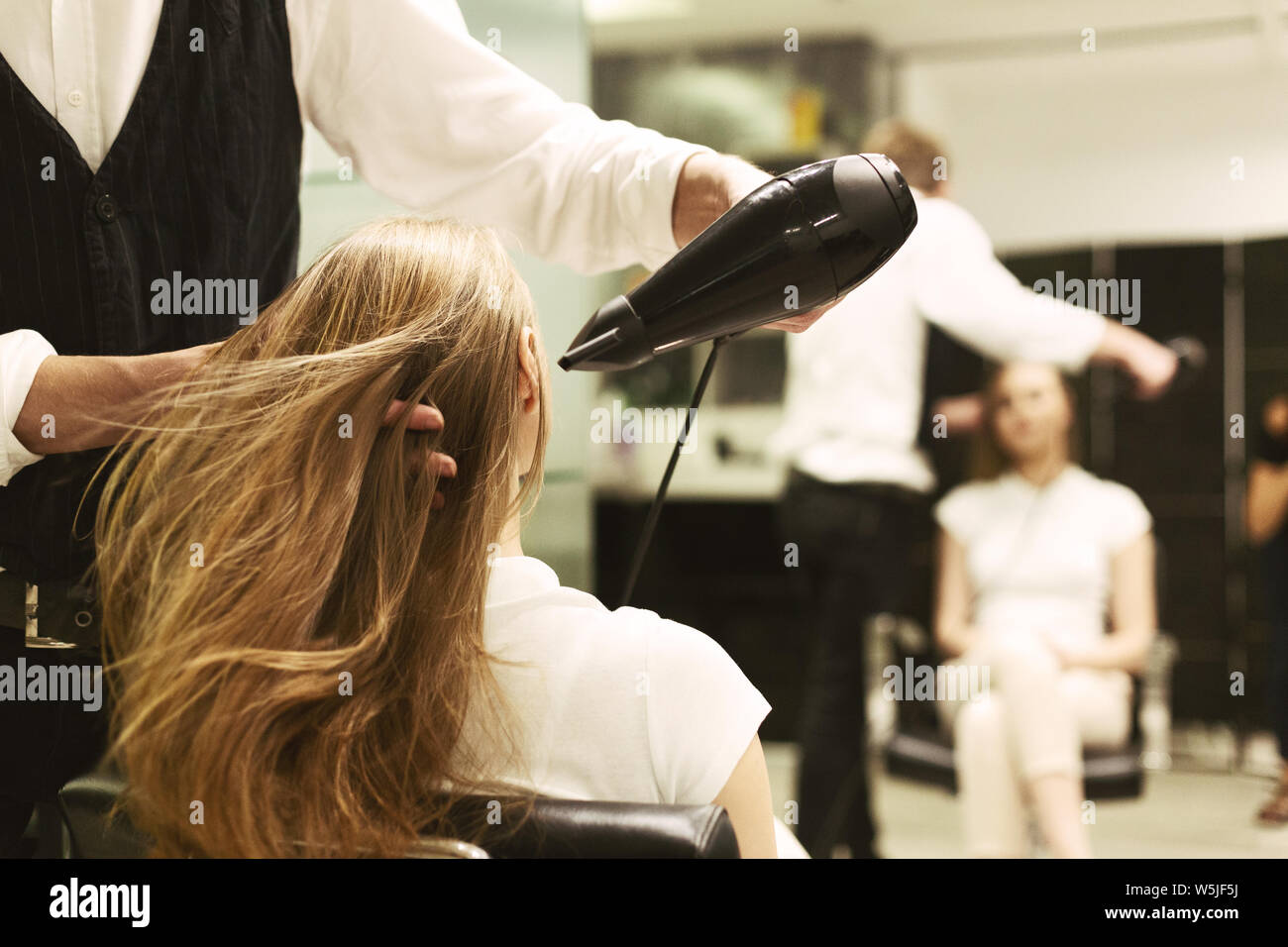 Woman drying hair in mirror hi-res stock photography and images - Alamy