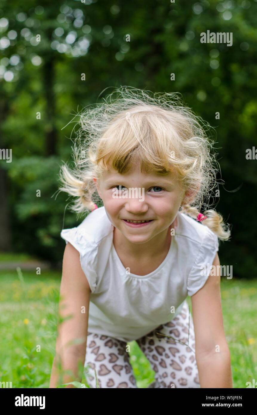 beautiful blond girl lying on meadow Stock Photo