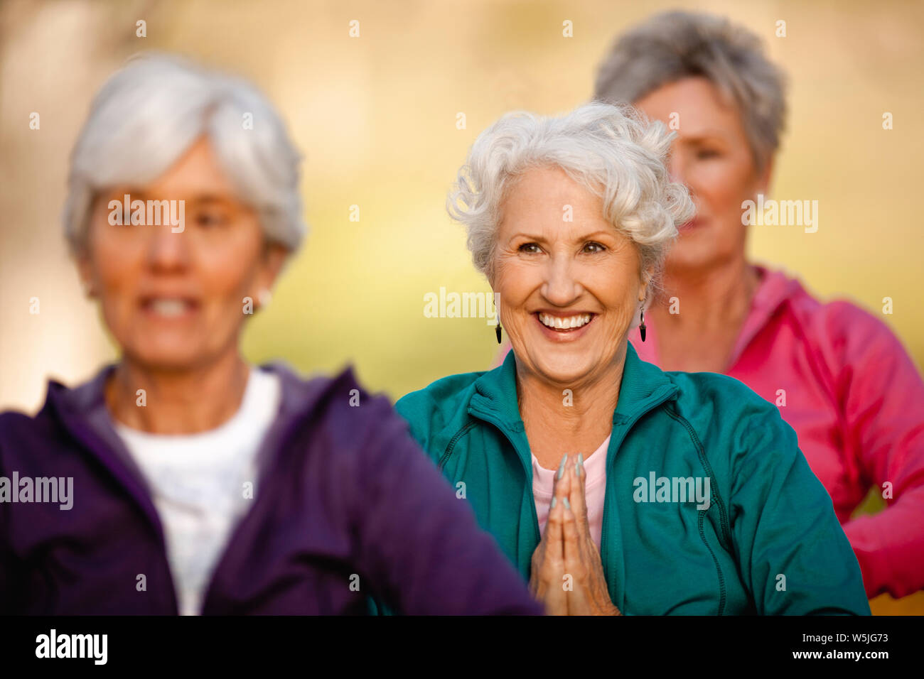 Three women doing yoga on hi-res stock photography and images - Alamy