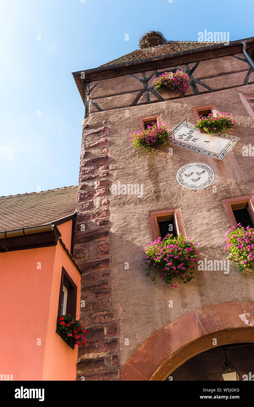 gate tower with flower decoration of Ammerschwihr, Alsace, Wine Route, France Stock Photo
