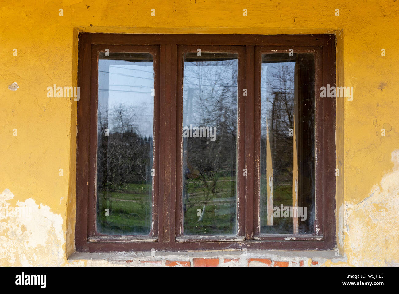 an old wooden window on a desolate house Stock Photo