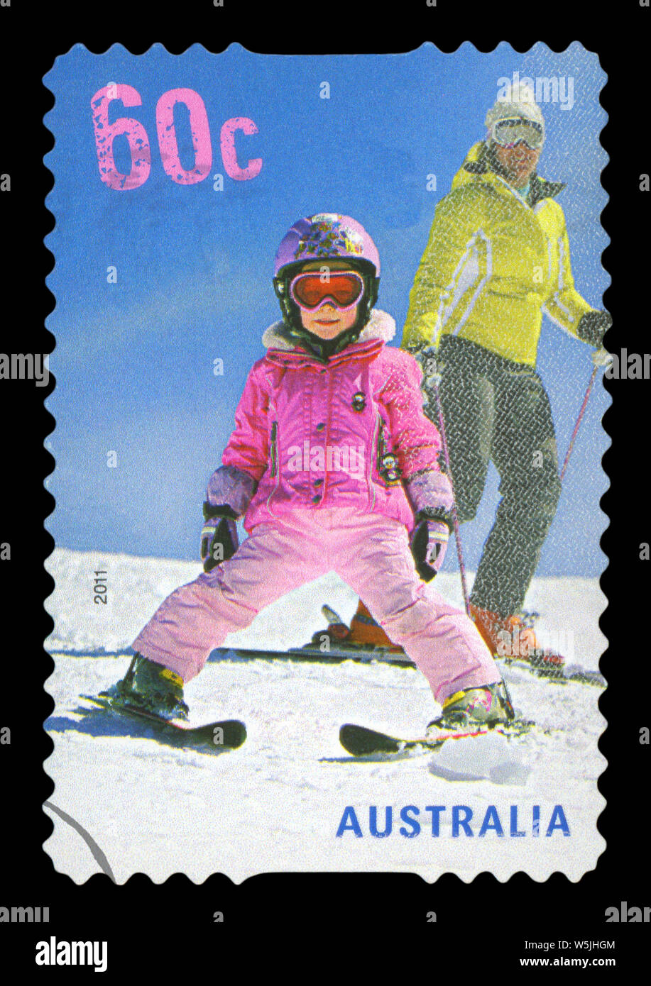 AUSTRALIA - CIRCA 2011: A used postage stamp from Australia, depicting an image of a child skiing with a parent, circa 2011. Stock Photo