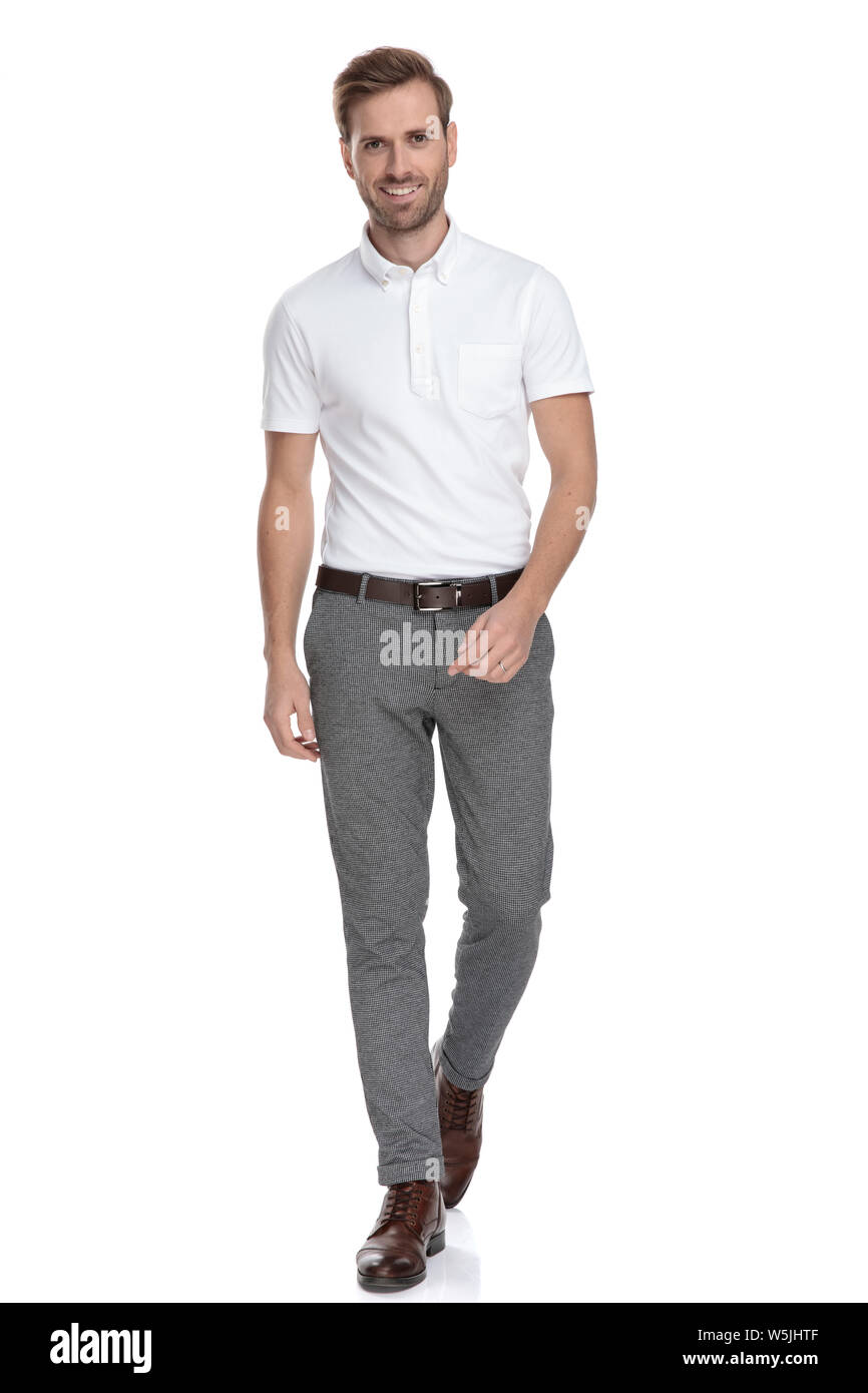 confident young casual man is walking forward on white background Stock ...