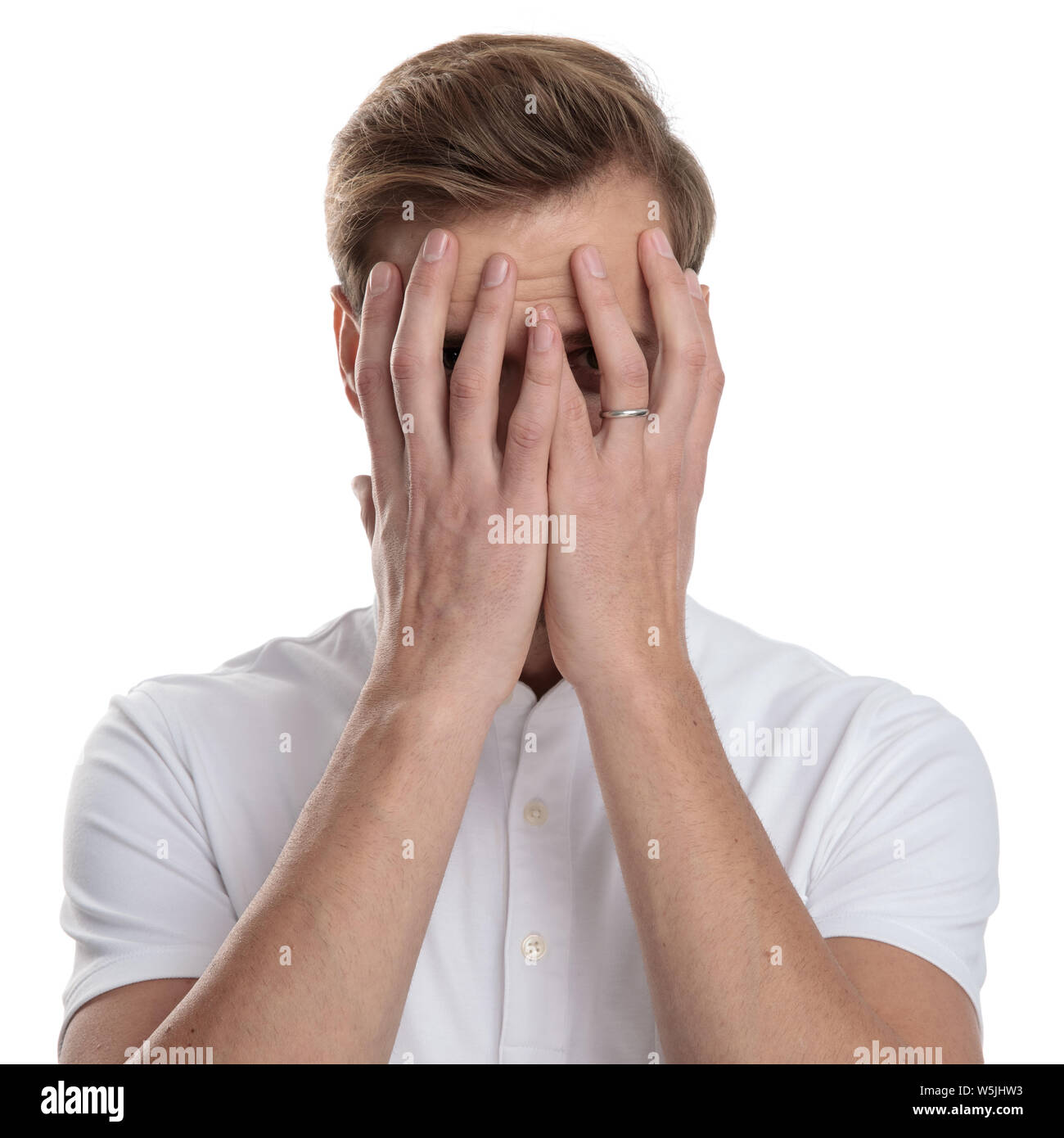 man covering his face with his palms on white background Stock Photo ...