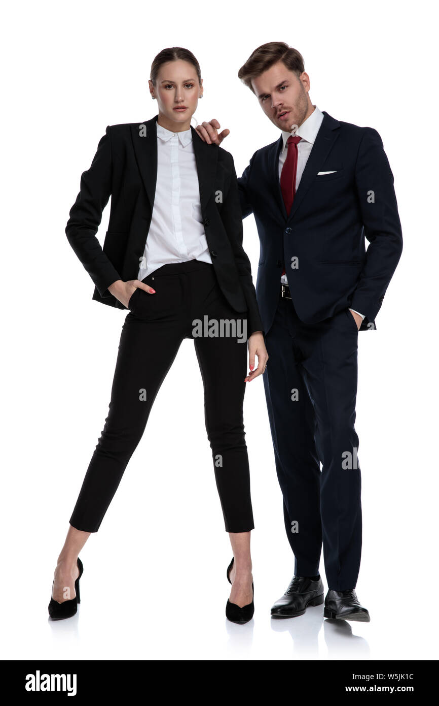 couple in business suits looking serious with attitude on white background Stock Photo