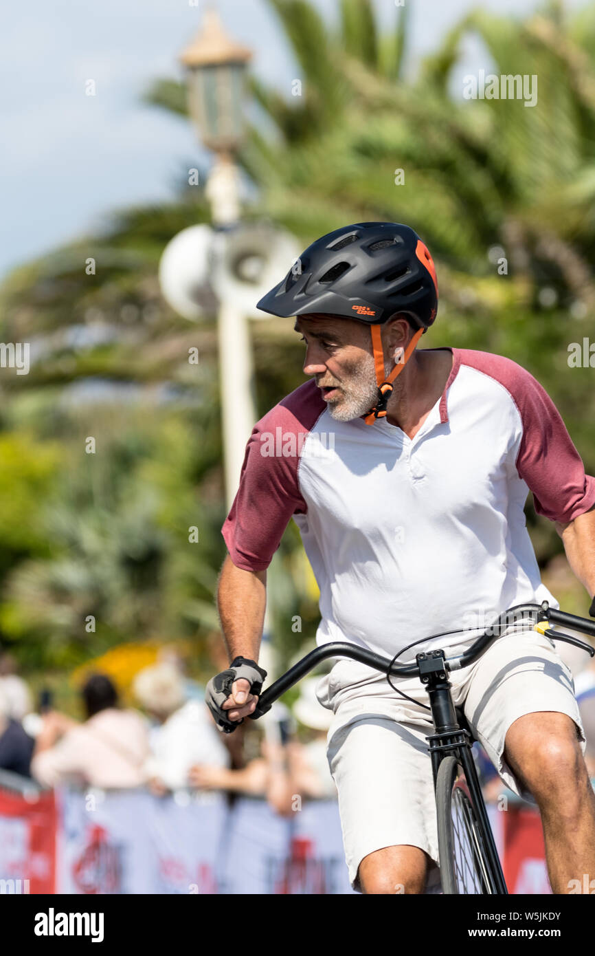 Racers of all abilities and on some interesting machines race and cycle around the streets of Eastbourne and the wider South downs of Sussex Stock Photo