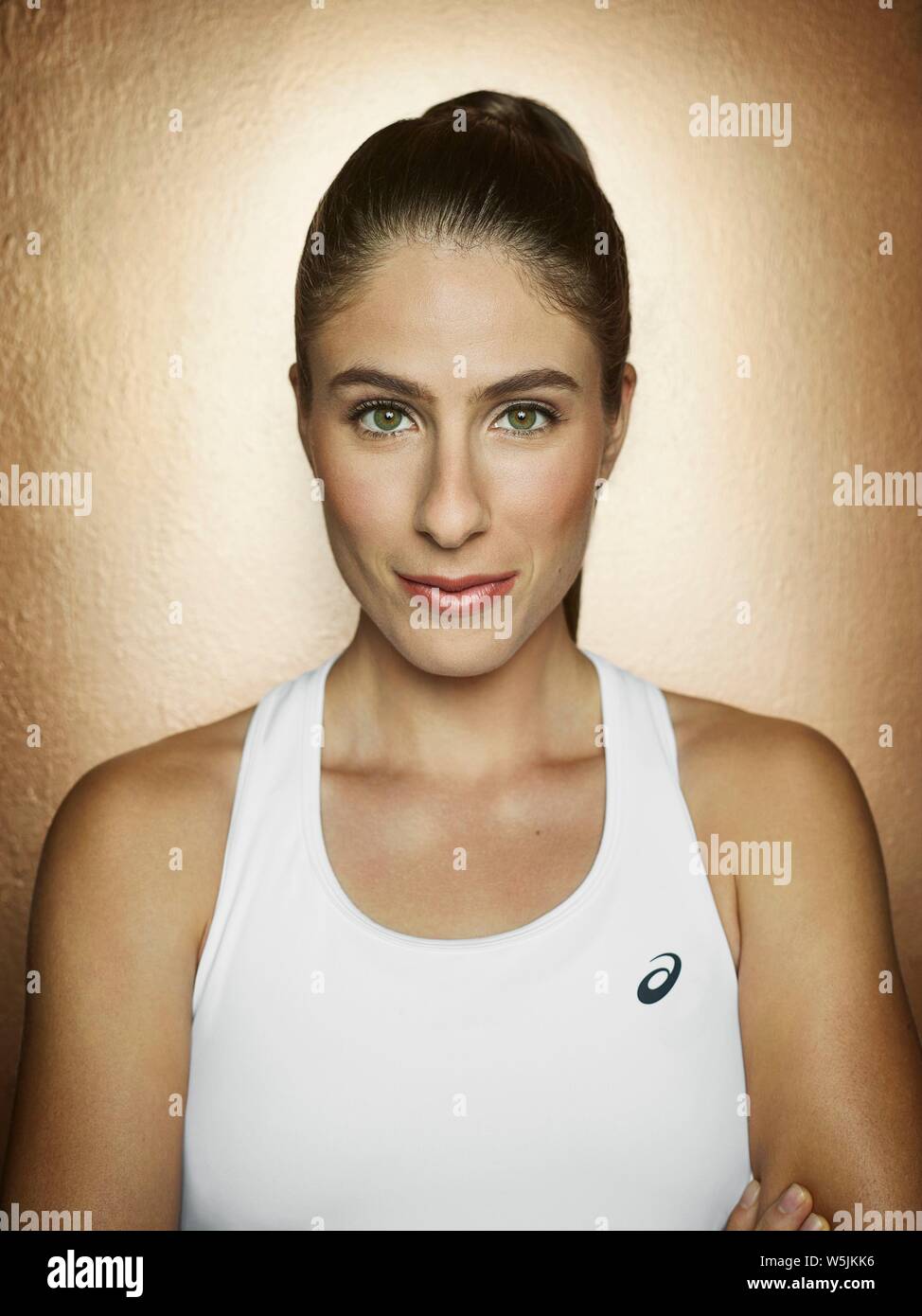 Portrait of female British Tennis player Jo Konta against a gold