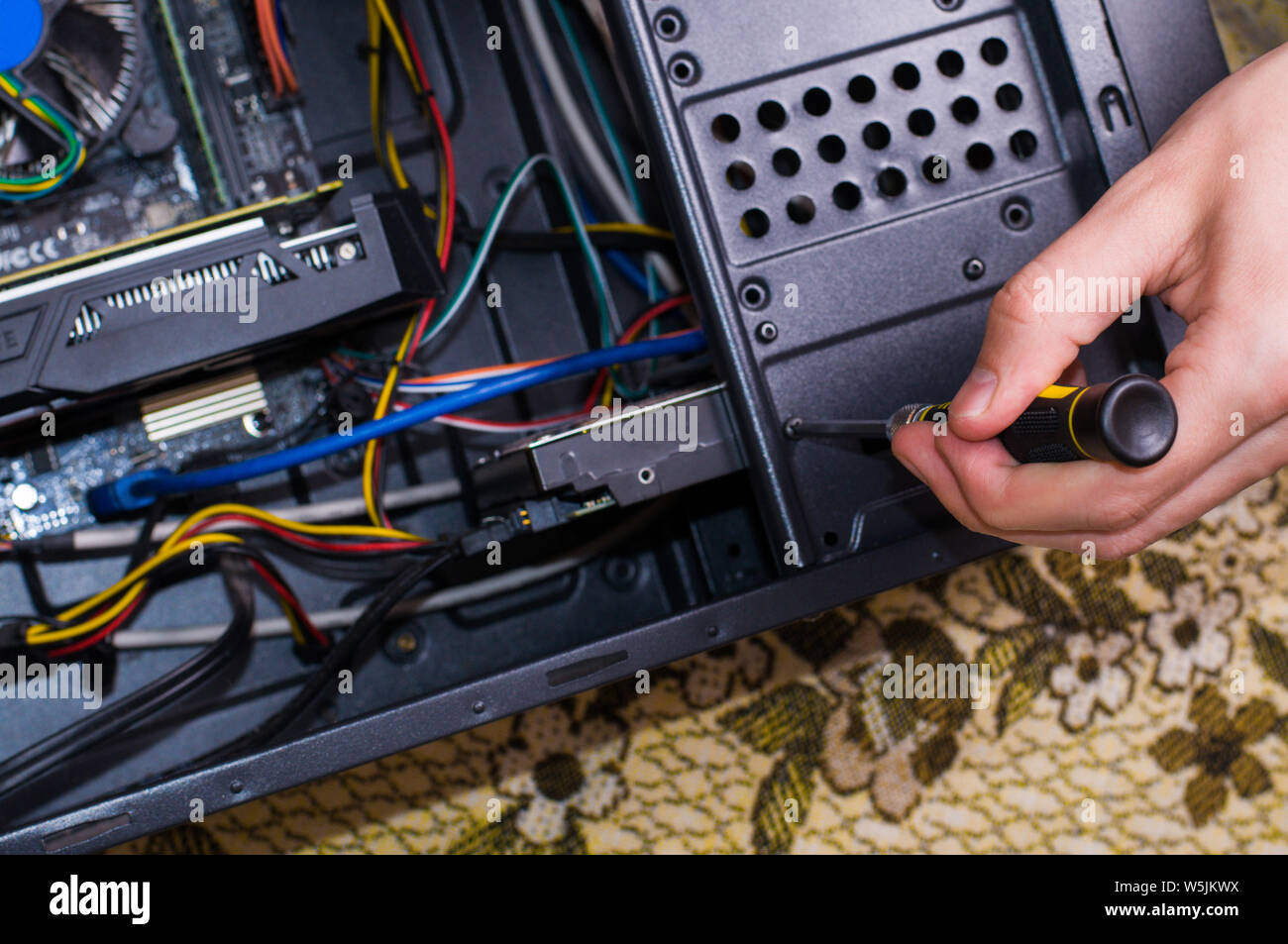 Computer repairing. Man repair black pc Stock Photo Alamy