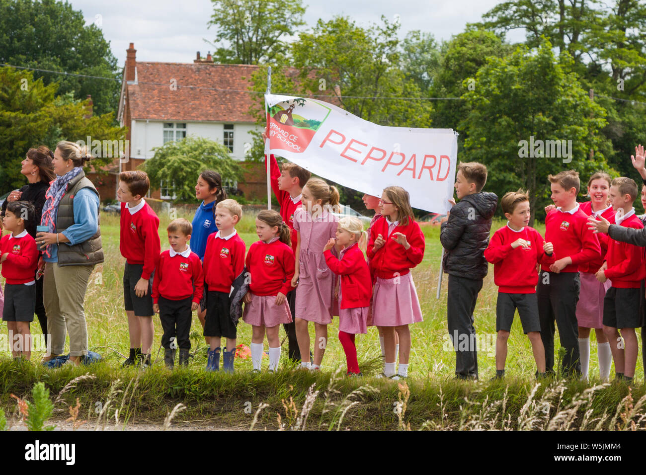 Excited school children from Peppard Church of England School wait for the OVO Energy Women's Tour to pass Stock Photo