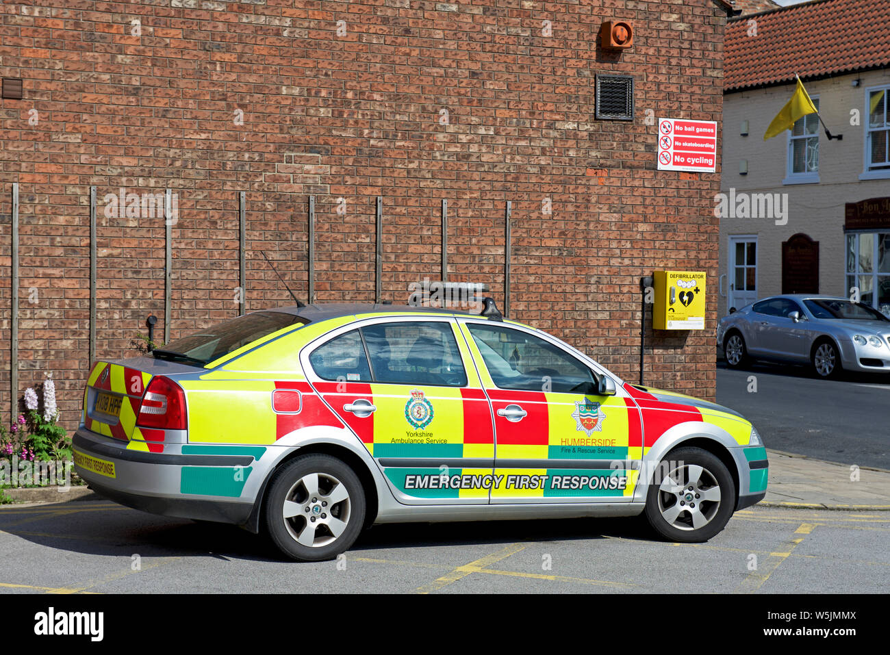 Emergency First Response vehicle parked next to defibrillator, England UK Stock Photo